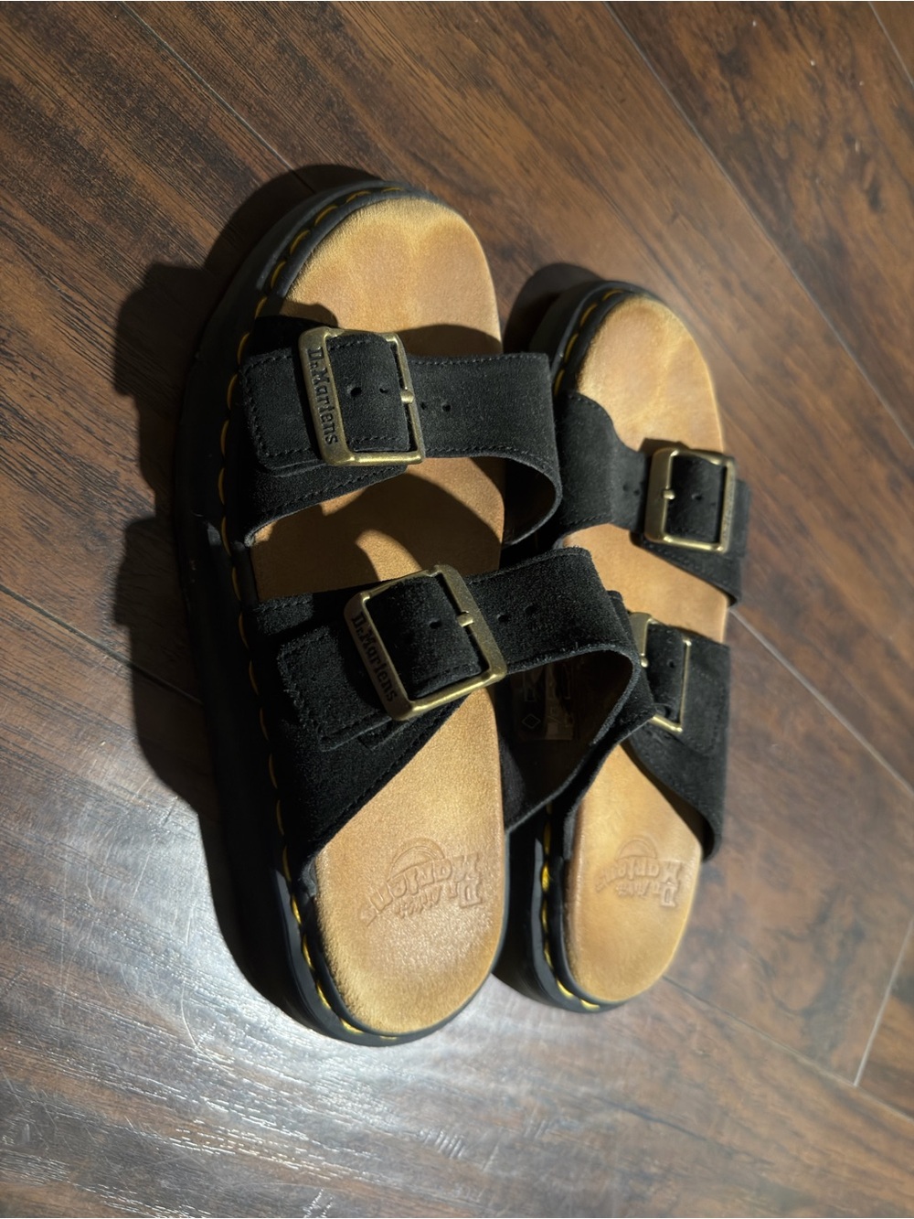 Dr. Martens women’s Black Suede Dual-Buckle Slide Sandals with Tan Footbed